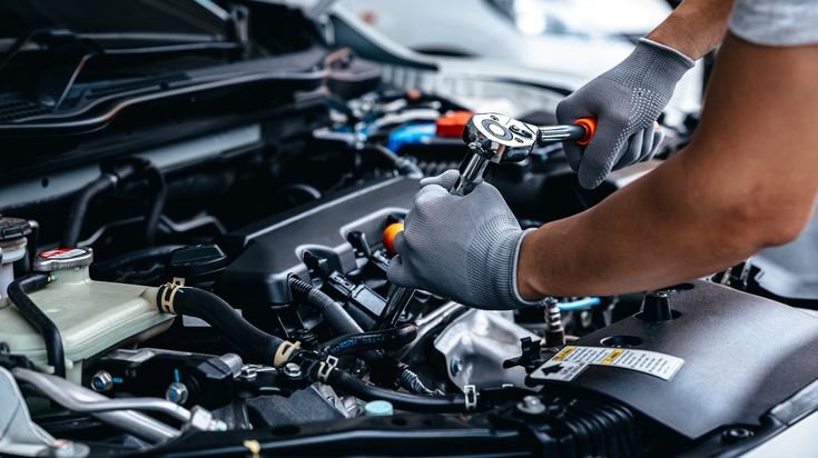Mechanic,Using,Wrench,While,Working,On,Car,Engine,At,Garage